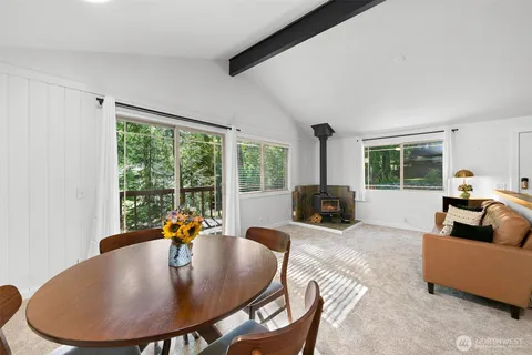 a living room with fireplace furniture and a large window