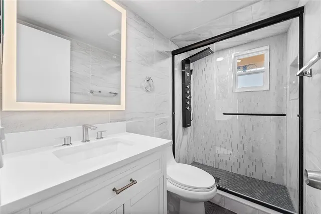 a bathroom with a sink toilet and shower