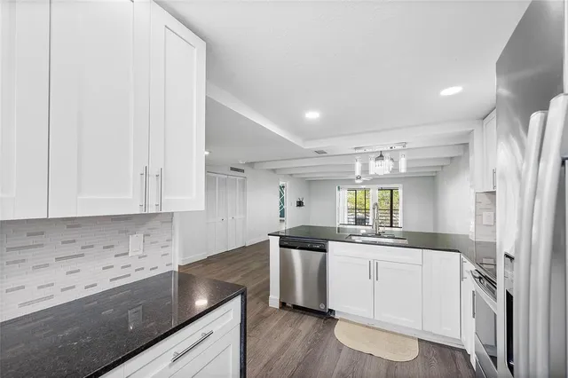 a kitchen with a sink cabinets and window