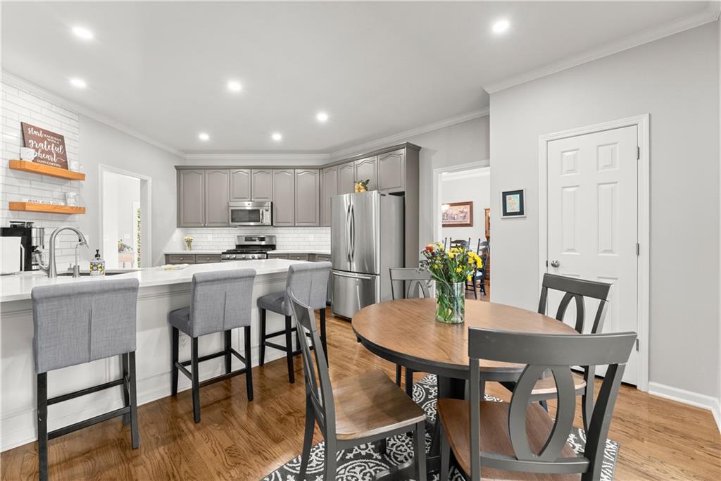 200 Morning Glory Ridge Canton, GA 30115 - Photo 16 of 88 a view of a dining room with furniture and wooden floor
