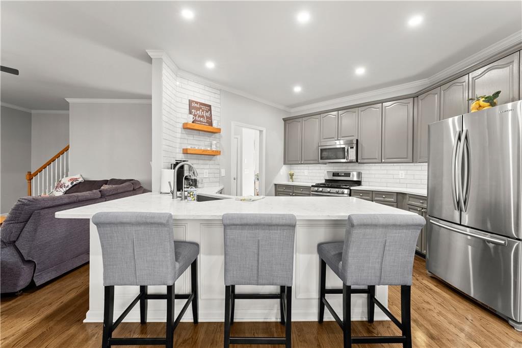 200 Morning Glory Ridge Canton, GA 30115 - Photo 17 of 88 a kitchen with stainless steel appliances granite countertop a dining table chairs refrigerator and microwave