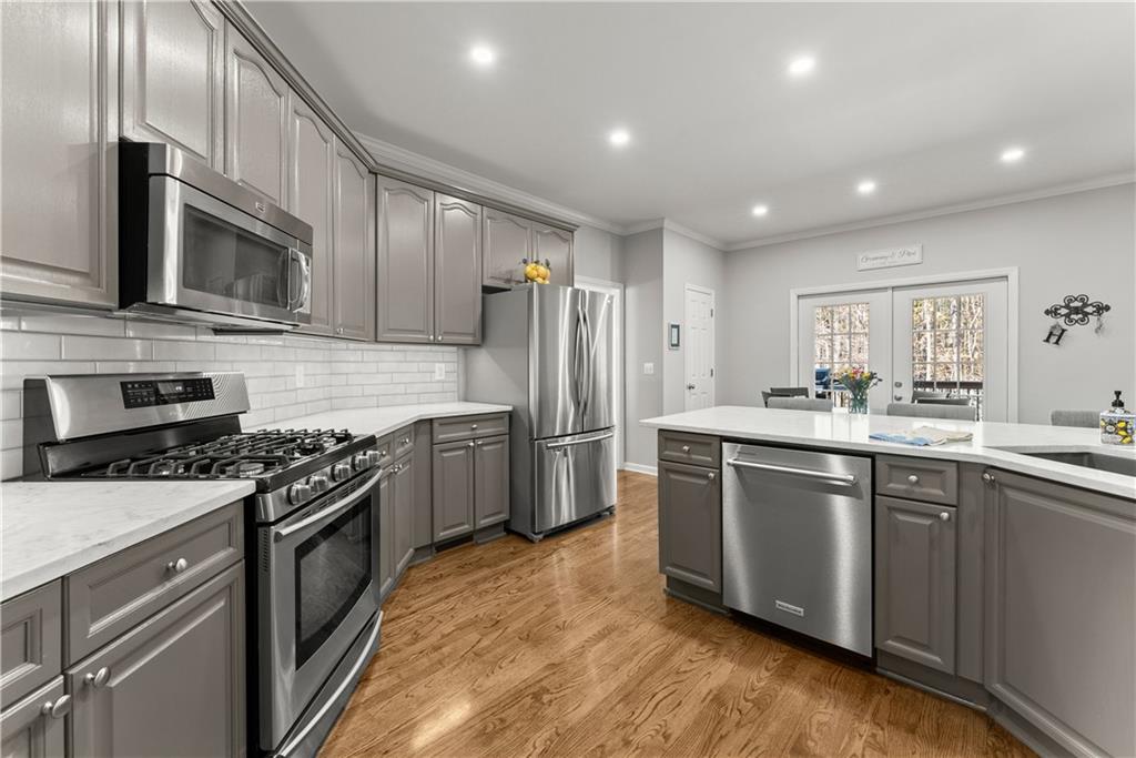 200 Morning Glory Ridge Canton, GA 30115 - Photo 20 of 88 a kitchen with stainless steel appliances granite countertop a stove top oven a sink and a refrigerator