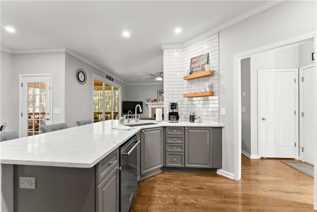 200 Morning Glory Ridge Canton, GA 30115 - Photo 22 of 88 a kitchen with stainless steel appliances granite countertop a sink and dishwasher a stove with wooden floor