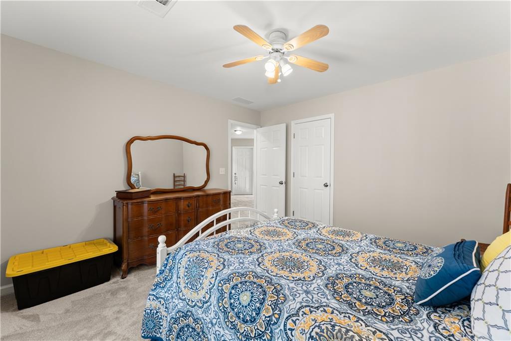 200 Morning Glory Ridge Canton, GA 30115 - Photo 47 of 88 a bedroom with a bed and a dresser