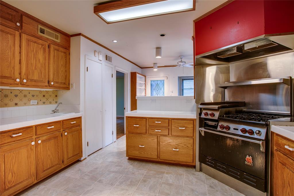 1439 Jr Drive Dallas, TX 75208 - Photo 10 of 39 a kitchen with stainless steel appliances granite countertop a stove and a refrigerator