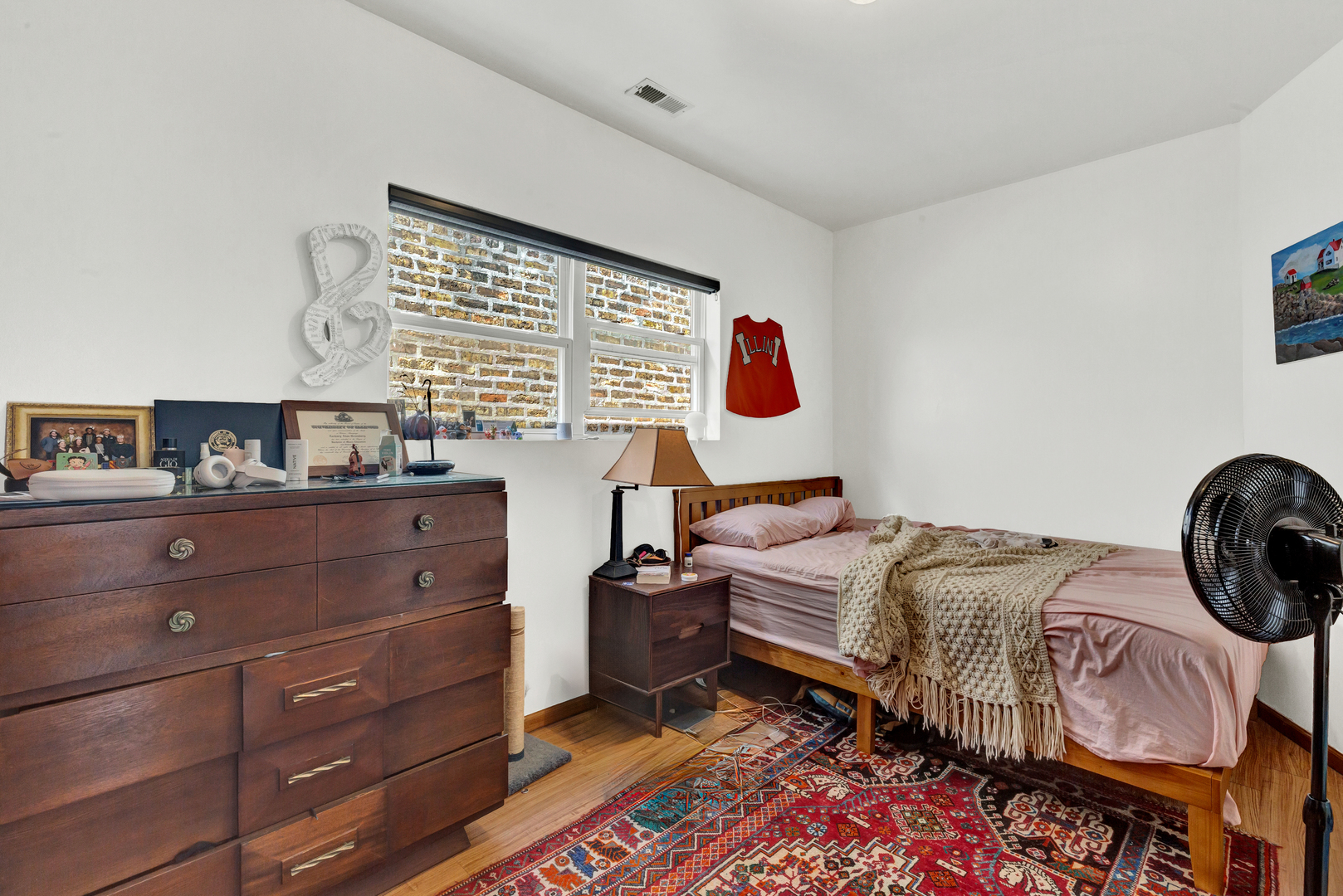 1422 North Maplewood Avenue Chicago, IL 60622 - Photo 4 of 9 a bedroom with a bed and a window