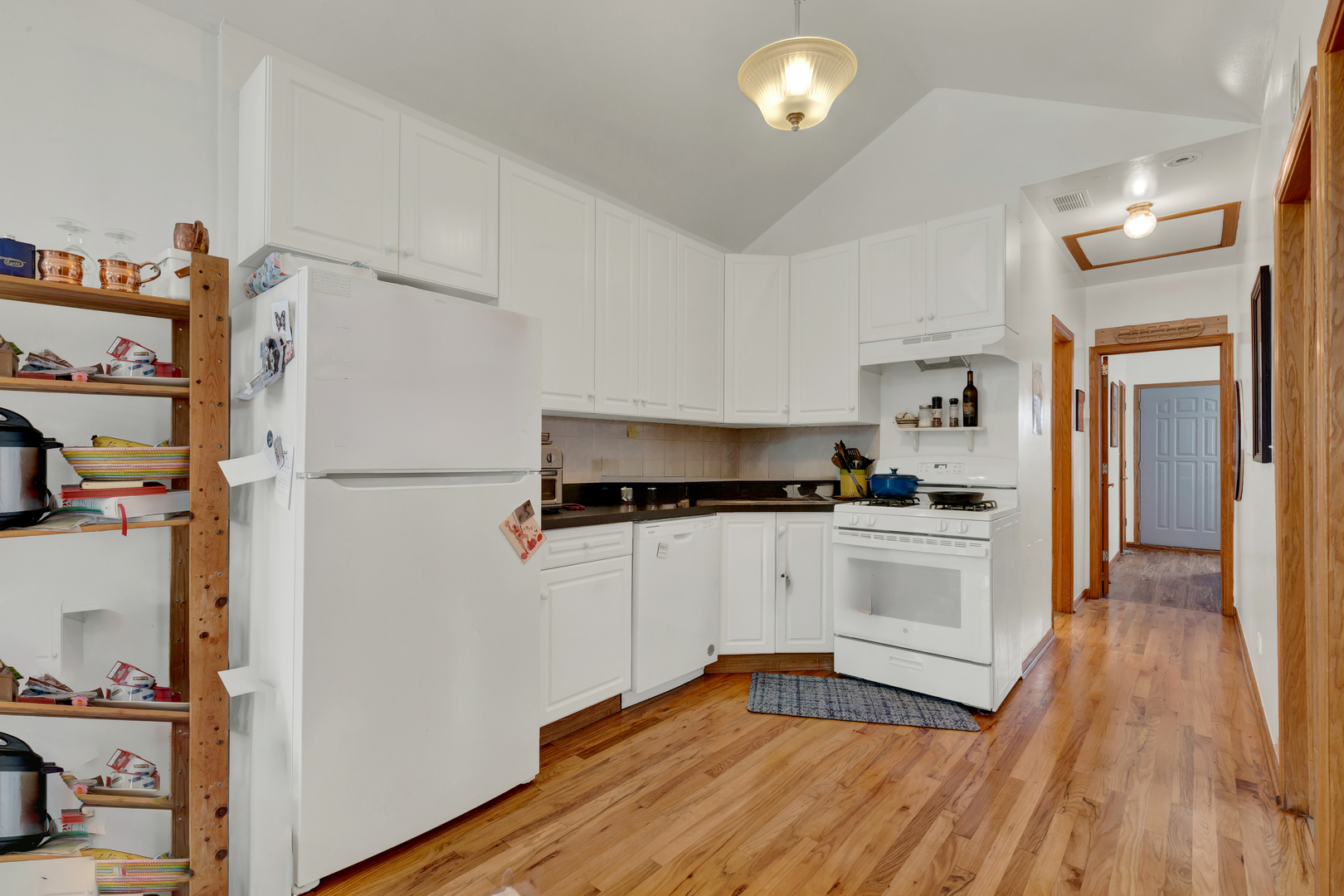 1422 North Maplewood Avenue Chicago, IL 60622 - Photo 5 of 9 a kitchen with a refrigerator and white cabinets
