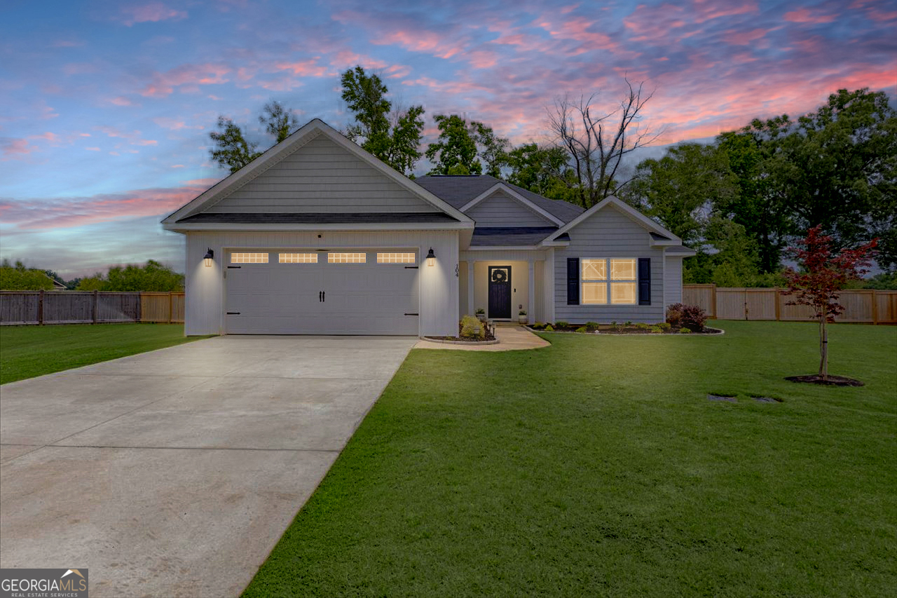 104 Meredith Layne Court Perry, GA 31069 - Photo 1 of 46 a front view of a house with a yard and garage