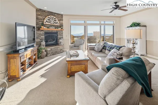 a living room with furniture flat screen tv and a fireplace