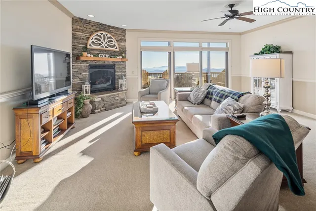 a living room with furniture flat screen tv and a fireplace