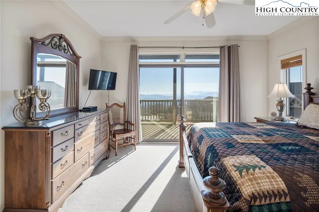 a bed room with a bed and a chandelier