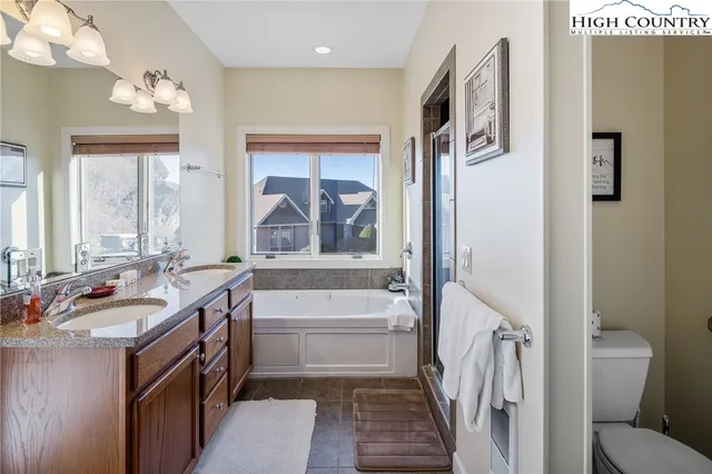 a bathroom with a tub sink and mirror