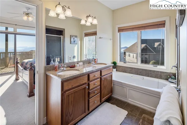 a bathroom with a tub sink and mirror