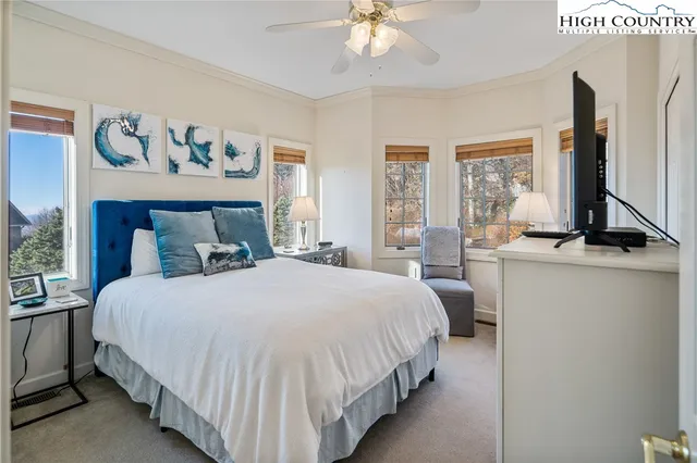 a bedroom with a large bed and a chandelier