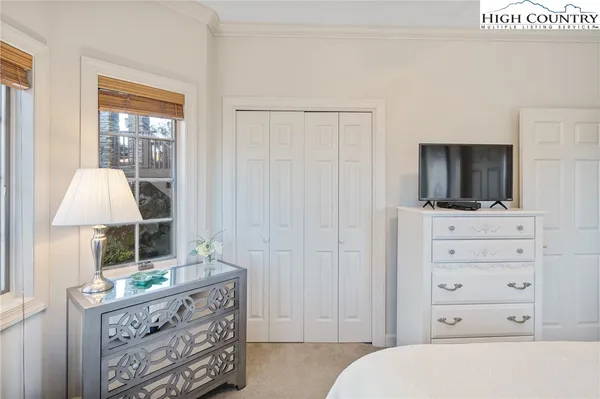 a bedroom with a bed and flat screen tv