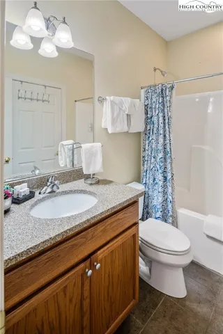 a bathroom with a sink toilet vanity and shower