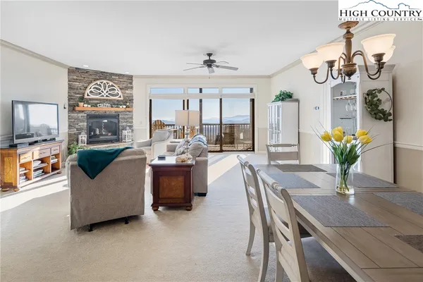 a living room with furniture and chandelier