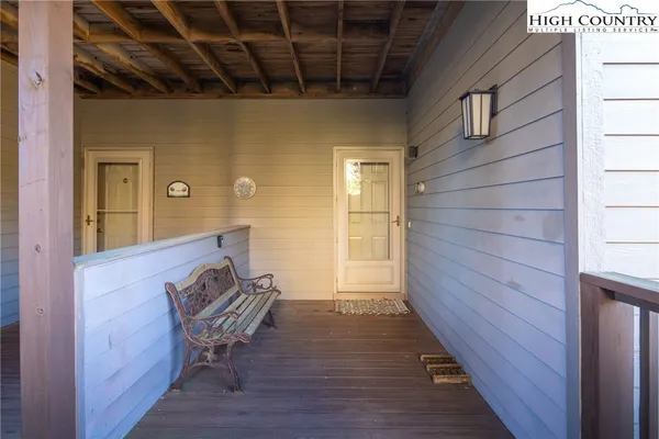 a view of chair and wooden floor in front of a door