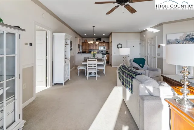 a living room with furniture and a chandelier