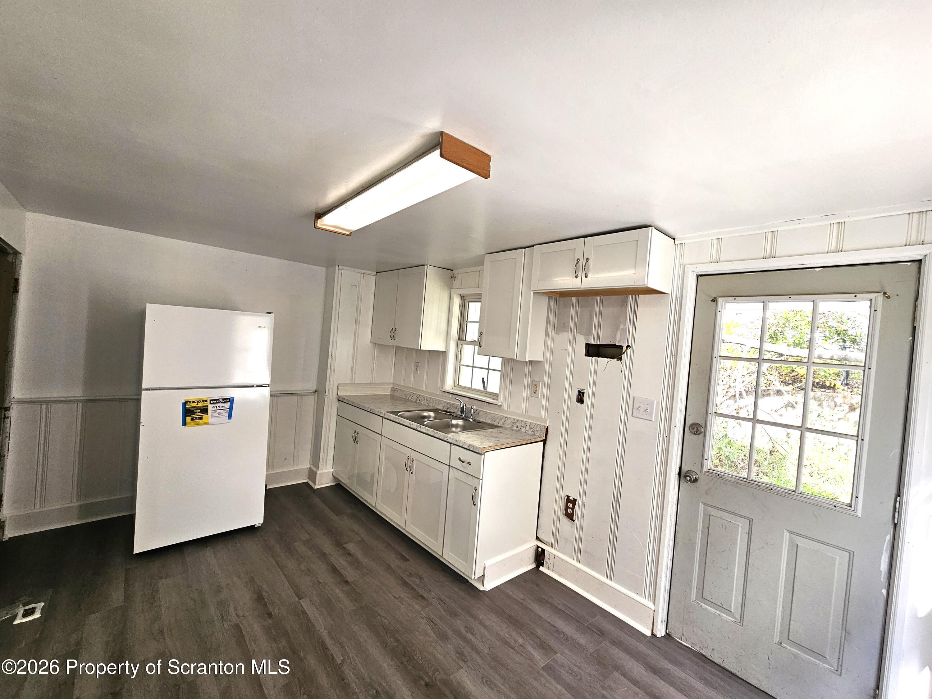 907 Green Ridge Street Scranton, PA 18509 - Photo 5 of 12 a kitchen with stainless steel appliances a stove a refrigerator and cabinets