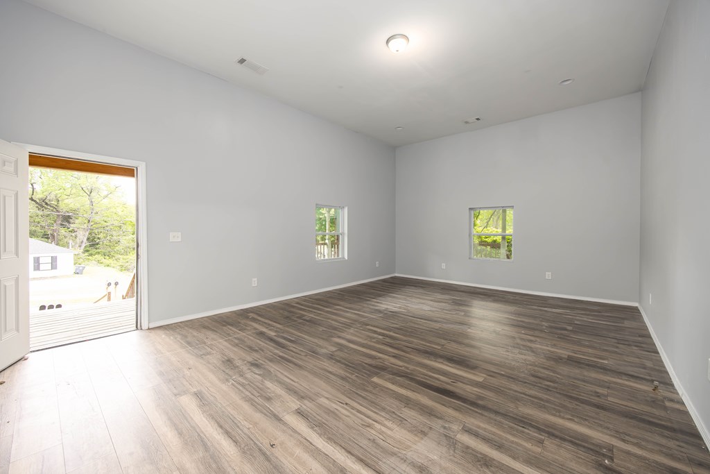 2113 Summerville Road Phenix City, AL 36867 - Photo 14 of 37 an empty room with wooden floor and windows