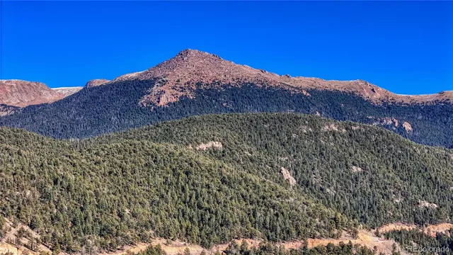 a view of a house with a mountain in the background