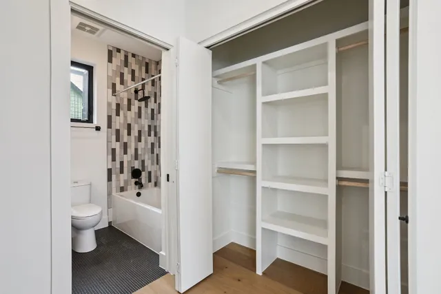 a white toilet sitting next to a bathroom sink