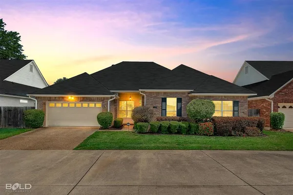 a front view of house with yard and green space