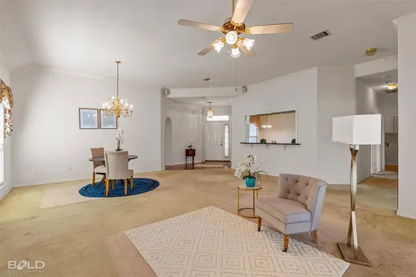 a living room with furniture and a chandelier