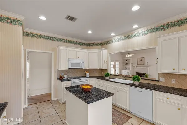 a kitchen with sink refrigerator and cabinets