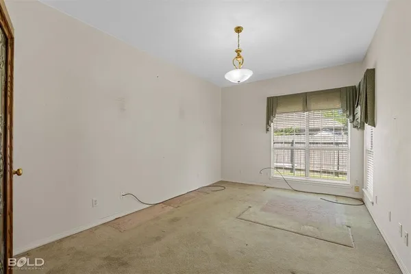an empty room with a empty space and windows