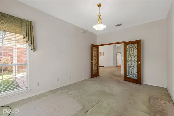 a view of an empty room with a window