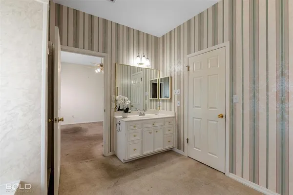 a view of a hallway with bathroom
