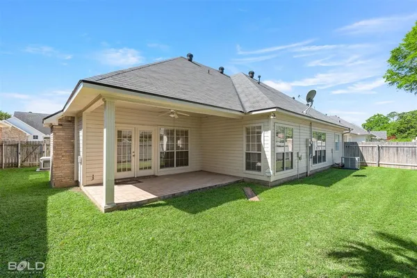 a view of a house with a yard and plants