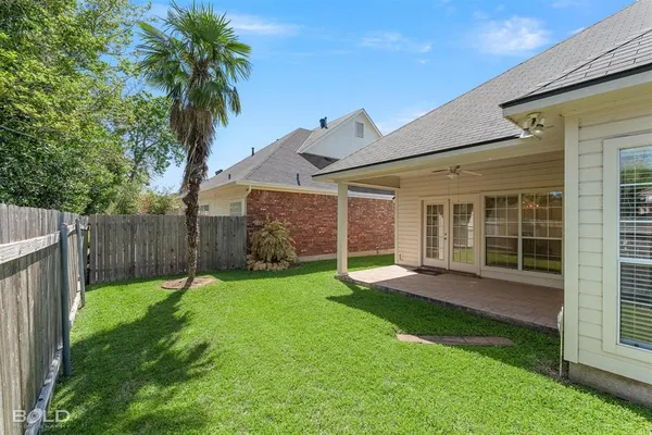 a view of a backyard with plants and a garden