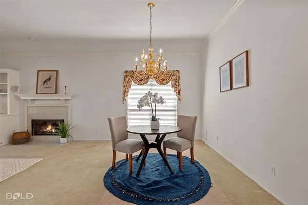a living room with furniture a fireplace and a chandelier