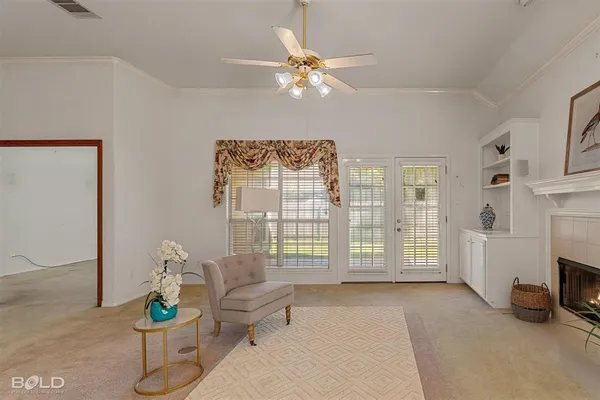a living room with furniture and a floor to ceiling window