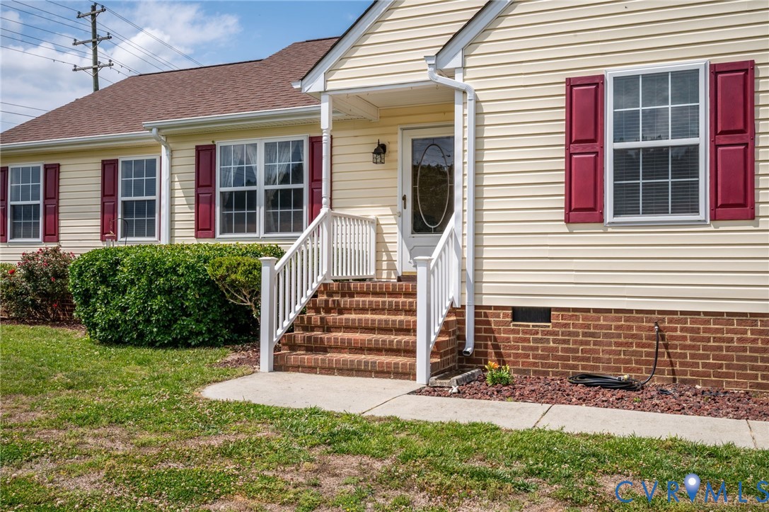 5280 West Quaker Road Disputanta, VA 23875 - Photo 19 of 33 a front view of a house with a yard