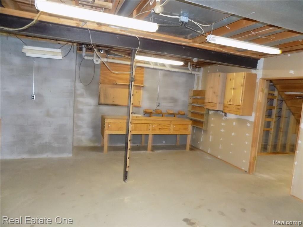 4650 Clyde Road Holly, MI 48442 - Photo 56 of 68 Workshop area in basement. Owner used as a woodworking shop