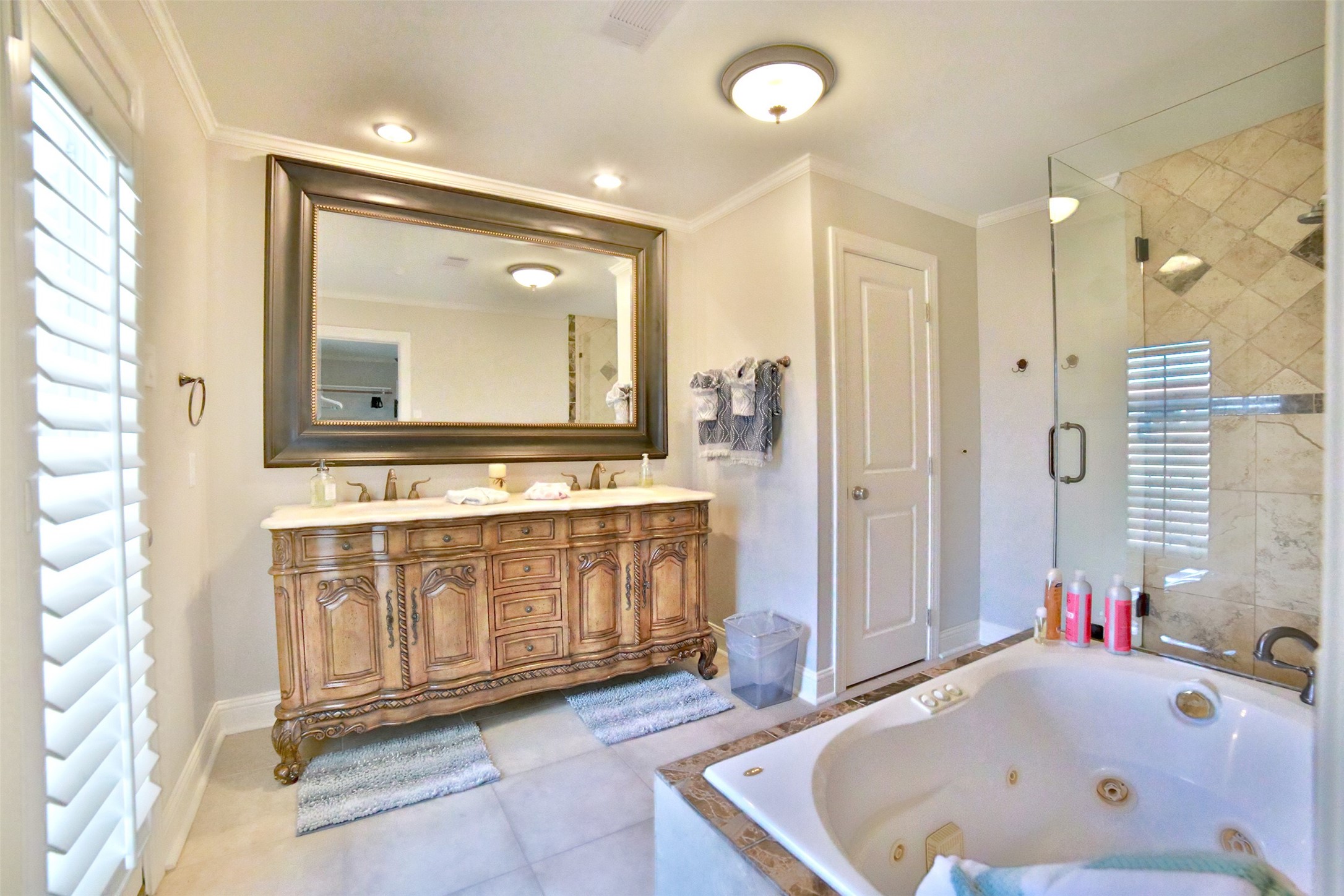 2625 Peckham Street Houston, TX 77098 - Photo 17 of 27 a bathroom with a tub a sink and a large mirror
