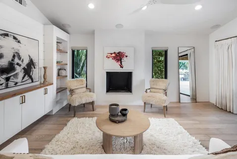a view of a kitchen with furniture and wooden floor