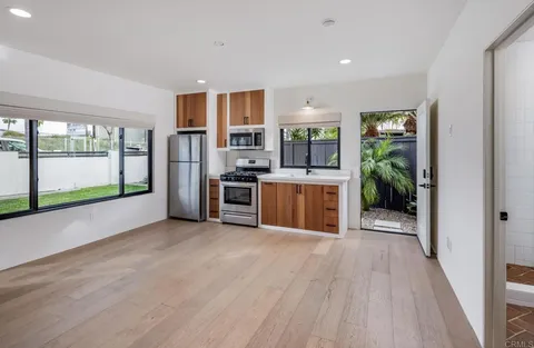 a kitchen with stainless steel appliances granite countertop a stove and a refrigerator