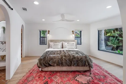 a bedroom with a large bed and a large window