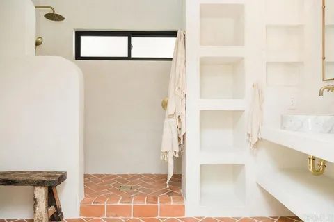 a bathroom with double vanity sinks and a mirror