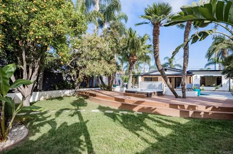 a view of a house with swimming pool and sitting area