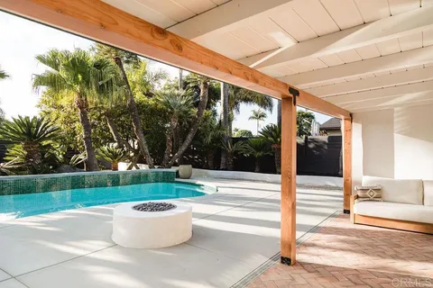 a front view of a house with garden and porch