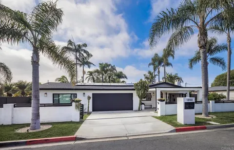 a front view of a house with a garden and a yard