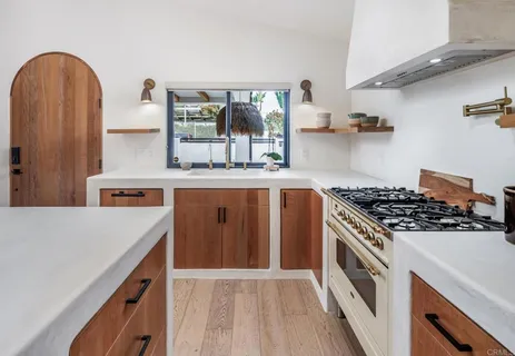 a kitchen with stainless steel appliances granite countertop a stove and a sink
