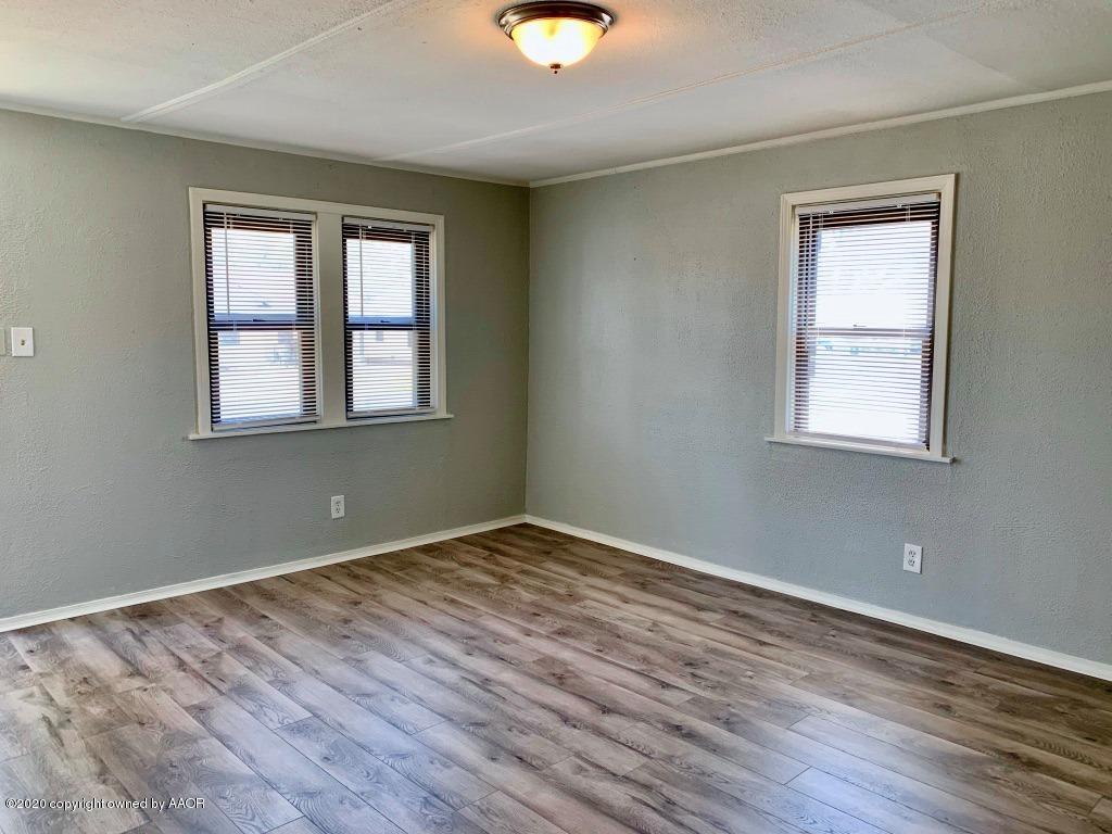 4106 South Harrison Street Amarillo, TX 79110 - Photo 3 of 19 a view of an empty room with wooden floor and a window