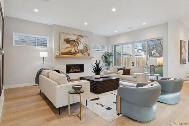 a living room with furniture fireplace and window
